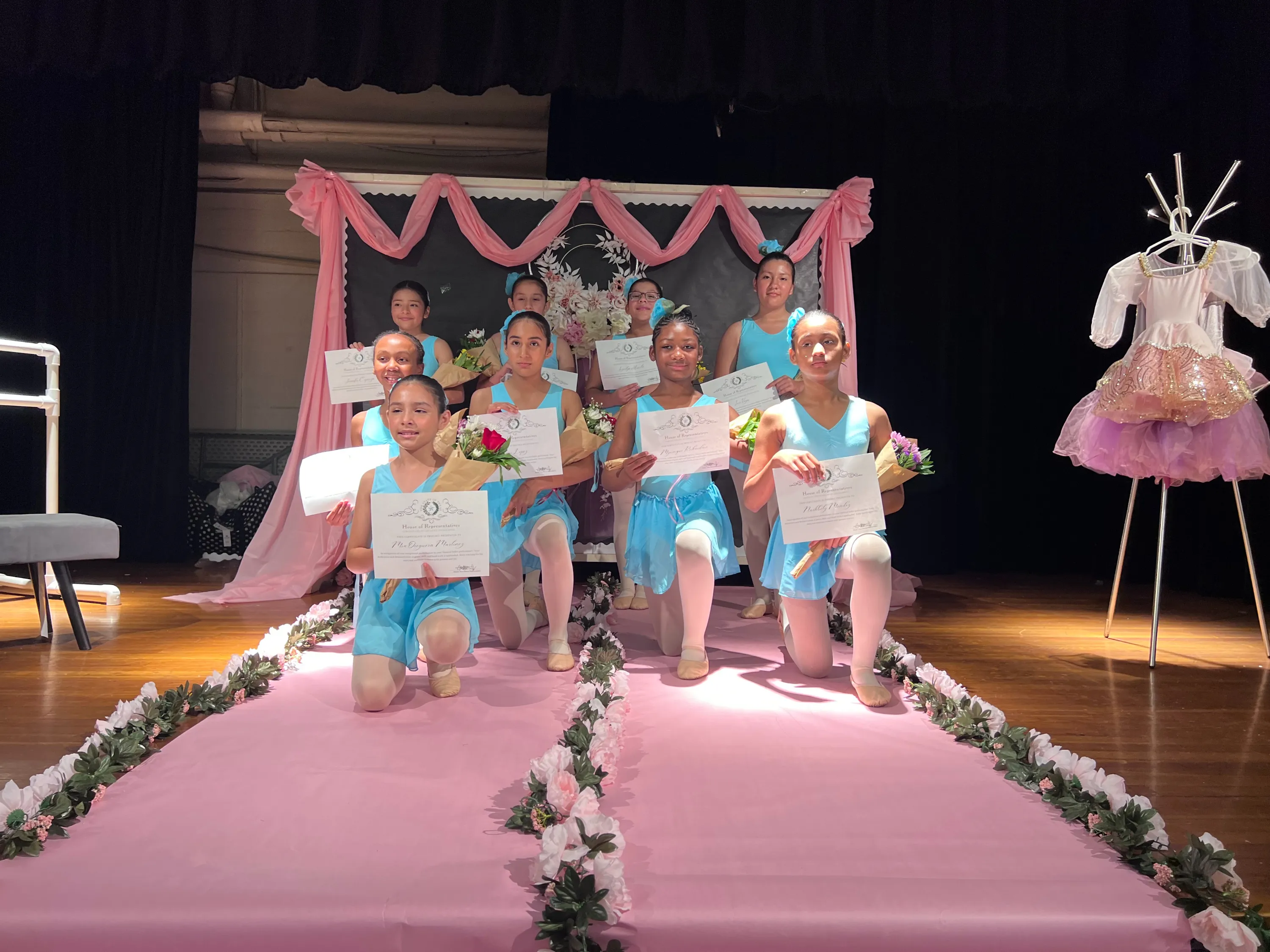 IMAGINE... dancers kneeling on stage at their recital